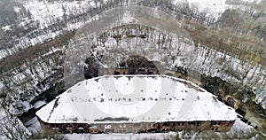 Aerial view of beautiful ancient fortress in forest in winter. Tarakaniv Fort.