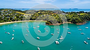 Aerial view on beautiful bay with sandy beach and residential houses on the background. Waiheke Island, Auckland, New Zealand