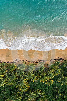 Aerial view of a beautiful beach in Maunabo, Puerto Rico against a cloudy blue sky