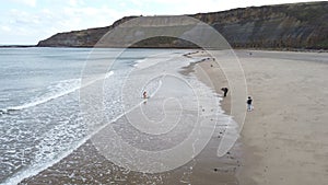 Aerial view of the beautiful Cayton Bay Beach on a gloomy day