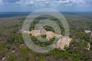 Aerial view of the beautiful Chicen Itza and Mayan Pyramid in Mexico surrounded with ground and greenery with ocean
