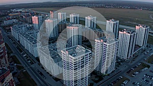 Aerial view of a beautiful city with high rise buildings and greenery. Stock footage. Concept of urbanization, houses on