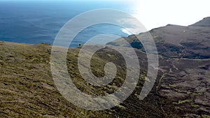 Aerial view of the beautiful coast at Malin Beg with Slieve League in the background in County Donegal, Ireland