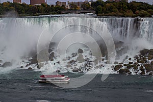 Aerial view of beautiful cruise ship with mesmerizing Niagara Falls waterfall in the background