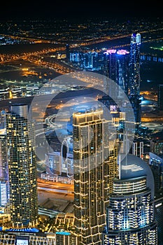 Aerial view of beautiful evening night illuminations scenic view of skyscraper and towers in Dubai. Street night traffic