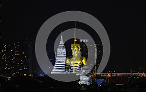 Aerial view of Beautiful The Giant Golden Buddha in Wat Paknam Phasi Charoen Temple in Phasi Charoen district at night