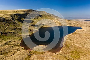 Aerial view of a beautiful glacially formed lake in a rural setting Llyn y Fan Fawr