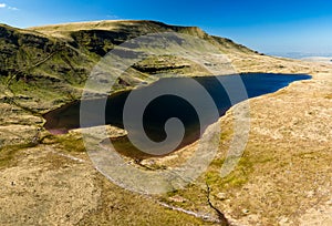 Aerial view of a beautiful glacially formed lake in a rural setting Llyn y Fan Fawr