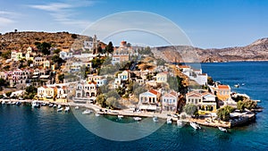 Aerial view of the beautiful greek island of Symi Simi with colourful houses and small boats. Greece, Symi island, view of the