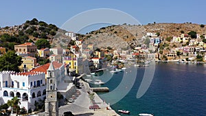 Aerial view of the beautiful greek island of Symi Simi with colourful houses and small boats. Greece, Symi island, view of the