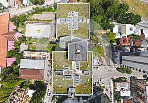 Aerial view of beautiful green roof living roof building by a nuclear themed soccer football court