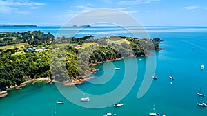 Aerial view on a beautiful harbour surrounding rocky peninsula with residential houses. Waiheke Island, Auckland, New Zealand