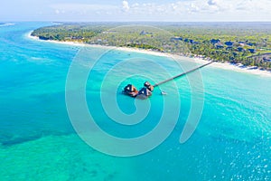 Aerial view of beautiful hotel in Indian ocean at sunset in summer. Zanzibar, Africa. Top view. Landscape with wooden hotel on the