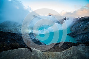 Aerial view of beautiful Ijen volcano with acid lake and sulfur gas going from crater