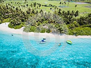 Aerial view of a beautiful island of the Maldives, Thoddoo with green trees and crystal clear water