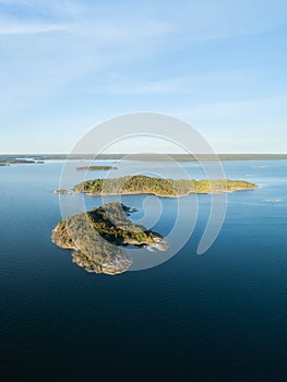 Aerial view of beautiful islands with green trees and rocks on the baltic sea at sunset in summer. photo
