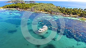 Aerial view of beautiful landscape, tourism boats, and people swimming on the sea and beach on May Rut island (a tranquil island