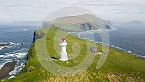 Aerial view of the beautiful lighthouse on Mykines island in Faroe Islands