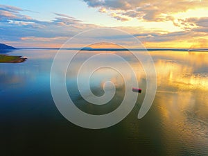 Aerial view  Beautiful Orange and red dramatic colors of sunset and cirrus clouds above the sea. Sky blue and orange natural dawn