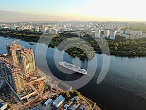 Aerial view beautiful panoramic cityscape at sunset. traffic of cars and passenger ships in the big city. drone shot