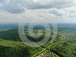 Aerial view beautiful panoramic landscape of green forest and fields against the backdrop of sky and clouds at sunset in summer