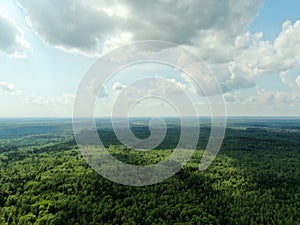 Aerial view beautiful panoramic landscape of green forest and fields against the backdrop of sky and clouds at sunset in summer