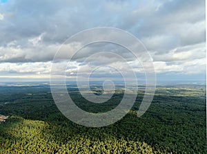 Aerial view beautiful panoramic landscape of green forest and fields against the backdrop of sky and clouds at sunset in summer