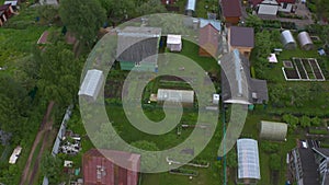 Aerial view of a beautiful Russian village on a cloudy summer day. Wooden houses. Country life.