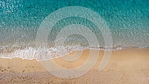 Aerial view of beautiful sandy beach and soft turquoise ocean wave. Tropical sea in summer season on Egremni beach on Lefkada