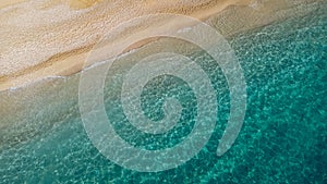 Aerial view of beautiful sandy beach and soft turquoise ocean wave. Tropical sea in summer season on Egremni beach on Lefkada