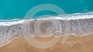 Aerial view of beautiful sandy beach and soft turquoise ocean wave. Tropical sea in summer season on Megali Petra beach on Lefkada