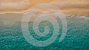 Aerial view of beautiful sandy beach and soft turquoise ocean wave. Tropical sea in summer season on Megali Petra beach on Lefkada