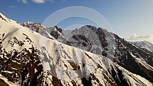 Aerial view of beautiful snowy mountains in Kyrgyzstan. Mountain peaks, summit. Beautiful untouched nature. Travel