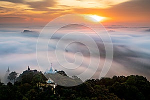 Aerial view of beautiful sunrise with pagoda on the top mountain peak, Surat Thani, Thailand