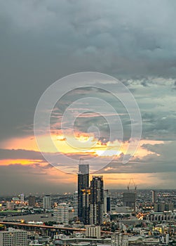 Aerial view of Beautiful sunset over large metropol city in Asia. There are prominent and isolated high-rise buildings along the
