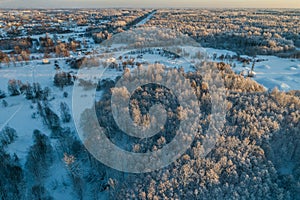 Aerial view of a beautiful sunset in the winter forest.