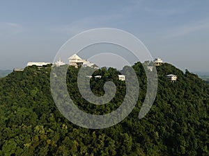 An aerial view of Beautiful Temple on the mountain stands prominently at Wat Nong Hoi in Ratchaburi near the Bangkok, Thailand.