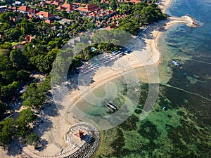 Aerial view of a beautiful tropical beach protected by a fringing tropical coral reef (Sanur, Bali
