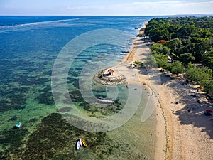 Aerial view of a beautiful tropical beach protected by a fringing tropical coral reef (Sanur, Bali
