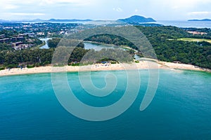 Aerial view of beautiful tropical beach and sea with palm and other tree in Phuket island for travel and vacation. Nai Han Beach