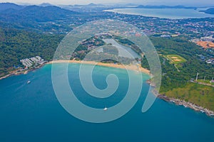 Aerial view of beautiful tropical beach and sea with palm and other tree in Phuket island for travel and vacation. Nai Han Beach