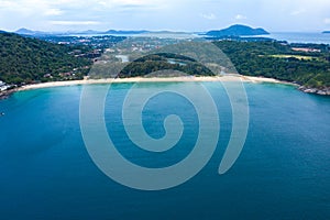 Aerial view of beautiful tropical beach and sea with palm and other tree in Phuket island for travel and vacation. Nai Han Beach