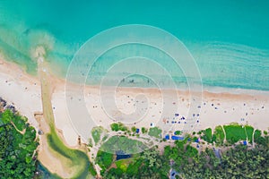 Aerial view of beautiful tropical beach and sea with palm and other tree in Phuket island for travel and vacation. Nai Han Beach