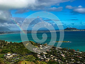 Aerial view of a beautiful tropical coastline with a rainbow on a bright summer day