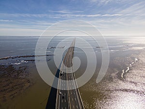 Aerial view of beautiful Vasco da Gama bridge`s suspended highway road crossing the Tagus river, one of the world`s longest brid