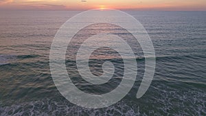 Aerial view Beautiful view sunset or sunrise over sea surface beautiful wave Amazing light twilight sky sunset Cinematic drone sho
