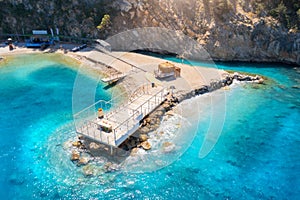 Aerial view of beautiful wooden pier, sea bay, sandy beach