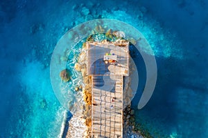 Aerial view of beautiful wooden pier, sea bay, sandy beach