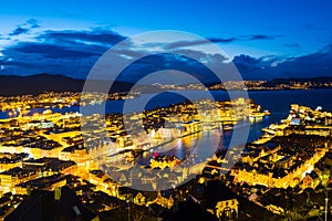 Aerial view of Bergen, Norway at night. Colorful cloudy sunset sky over the city