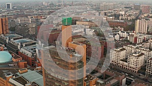 AERIAL: View of Berlin Germany Atrium Tower Potsdammer Platz Skyscraper Cityscape in beautiful orange autumn, winter